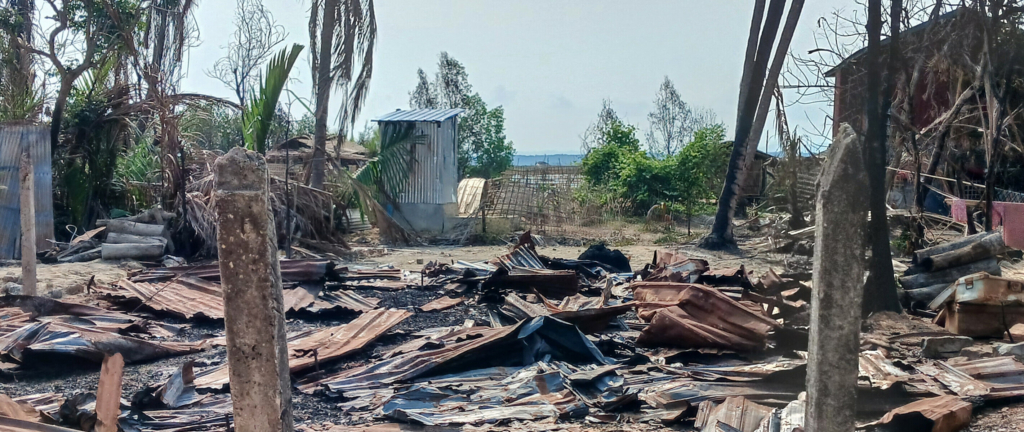 destroyed house and burned trees following fighting between Myanmar's military and the Arakan Army